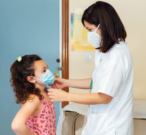 Doctor with child providing pediatric services