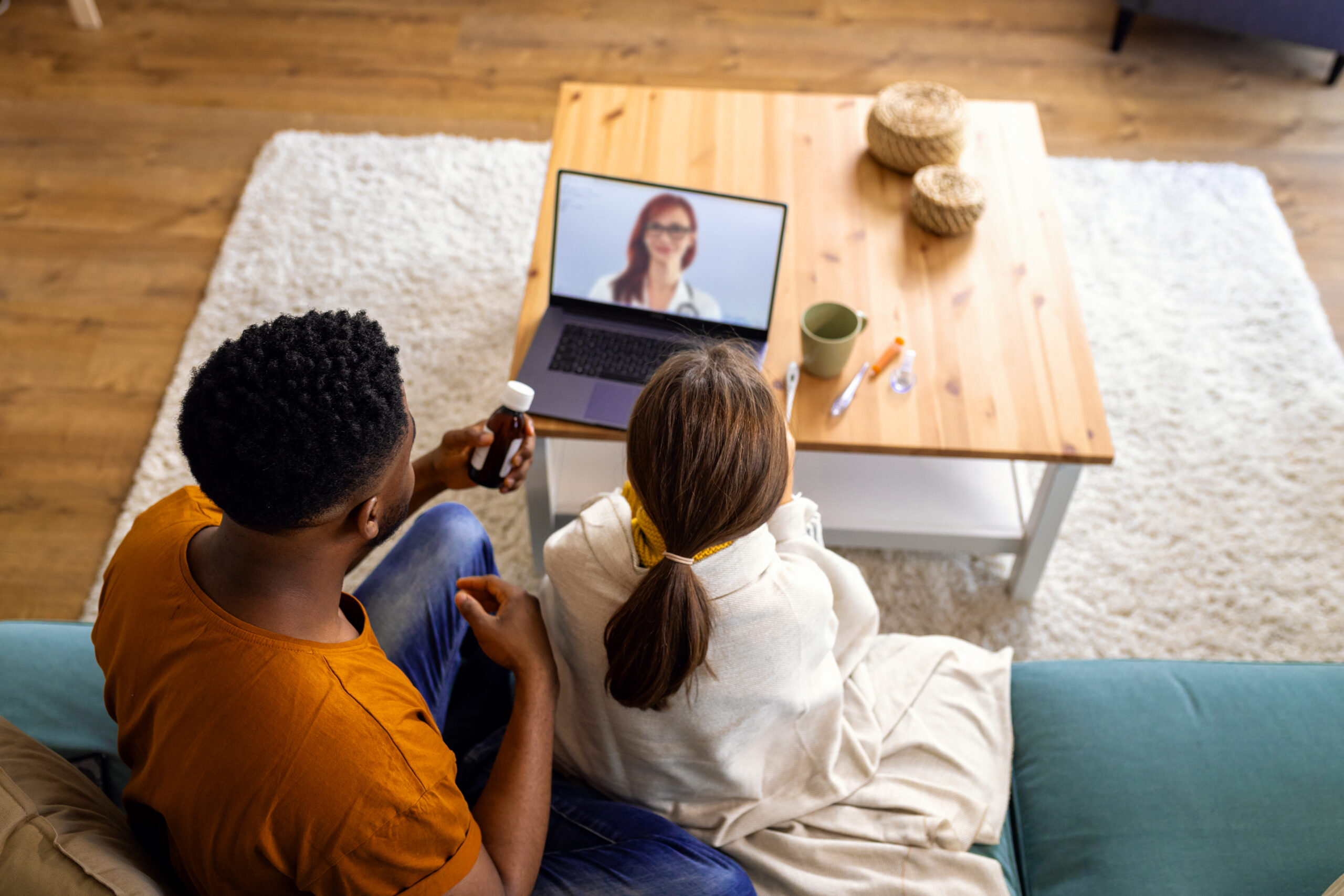 couple speaking with therapist on computer and partaking in telehealth or teletherapy