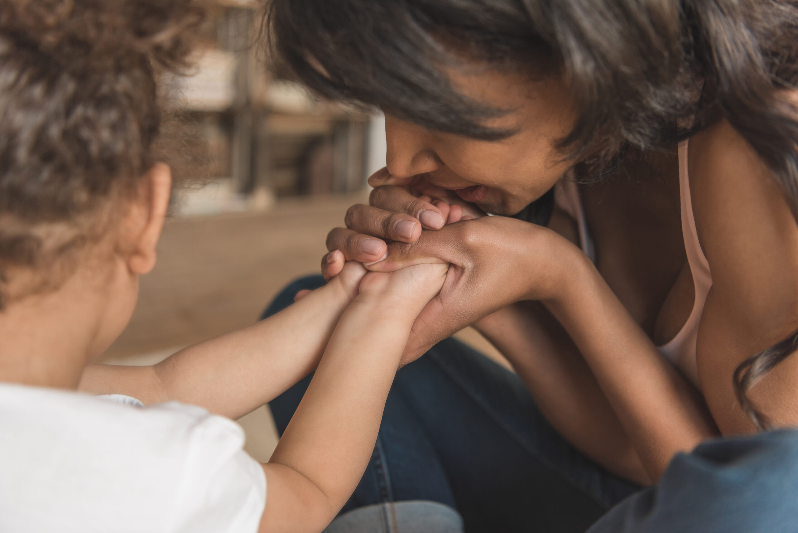 close up view of mother holding daughter's hands