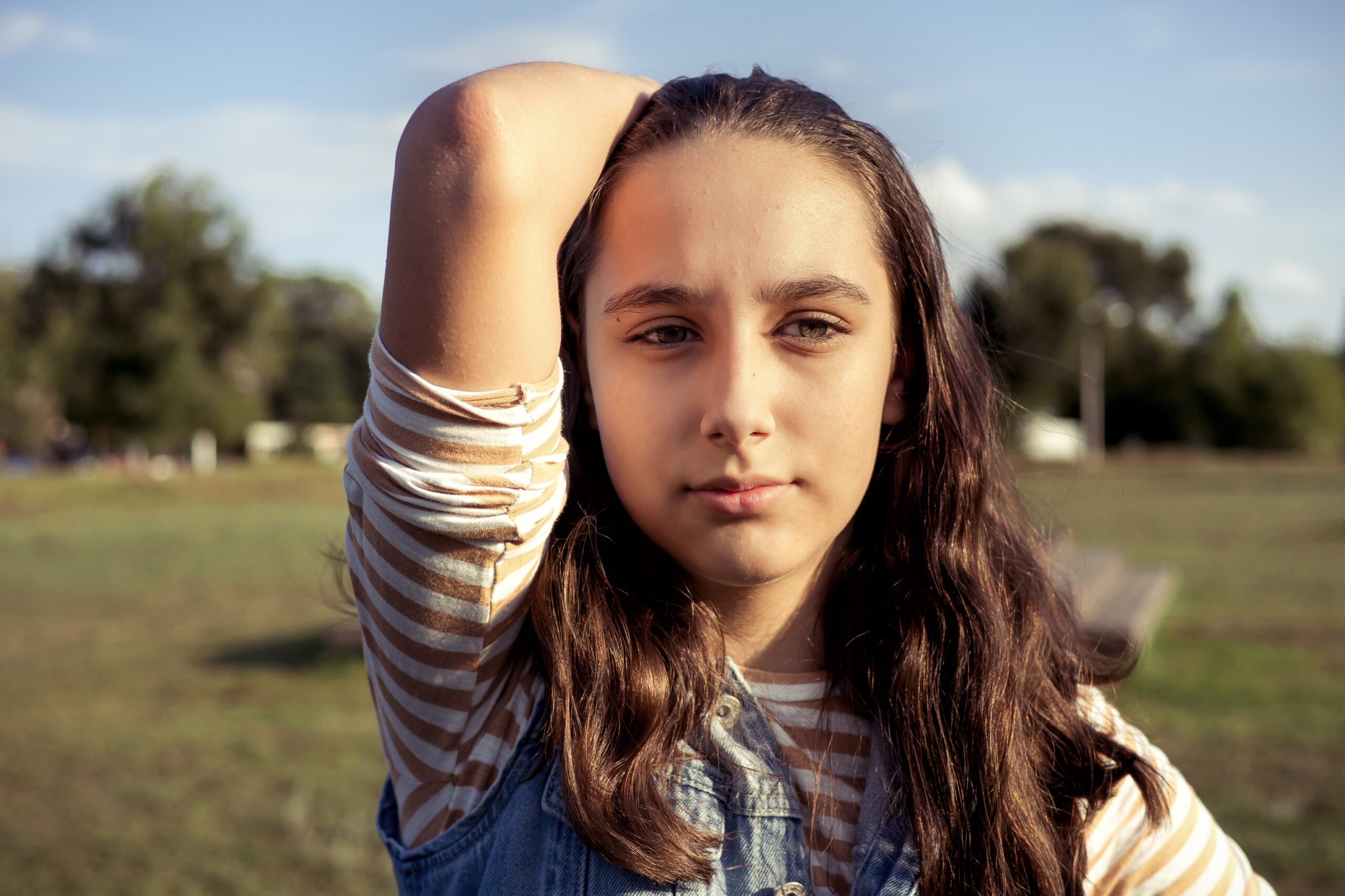 portrait of a teenager with her hand through her hair