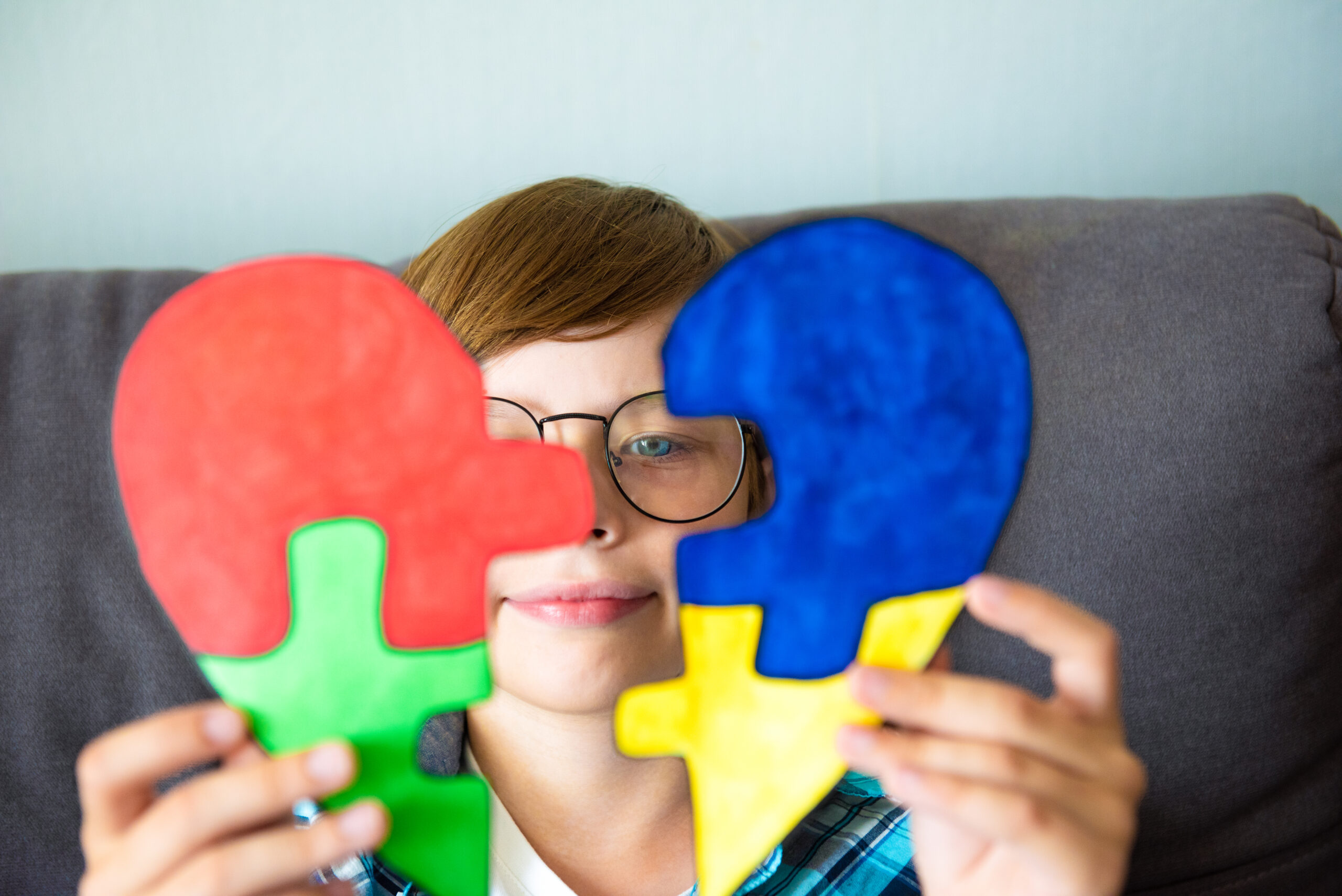 Preteen boy holding puzzle jigsaw heart shape, child mental health concept, world autism awareness day, teen autism spectrum disorder awareness concept