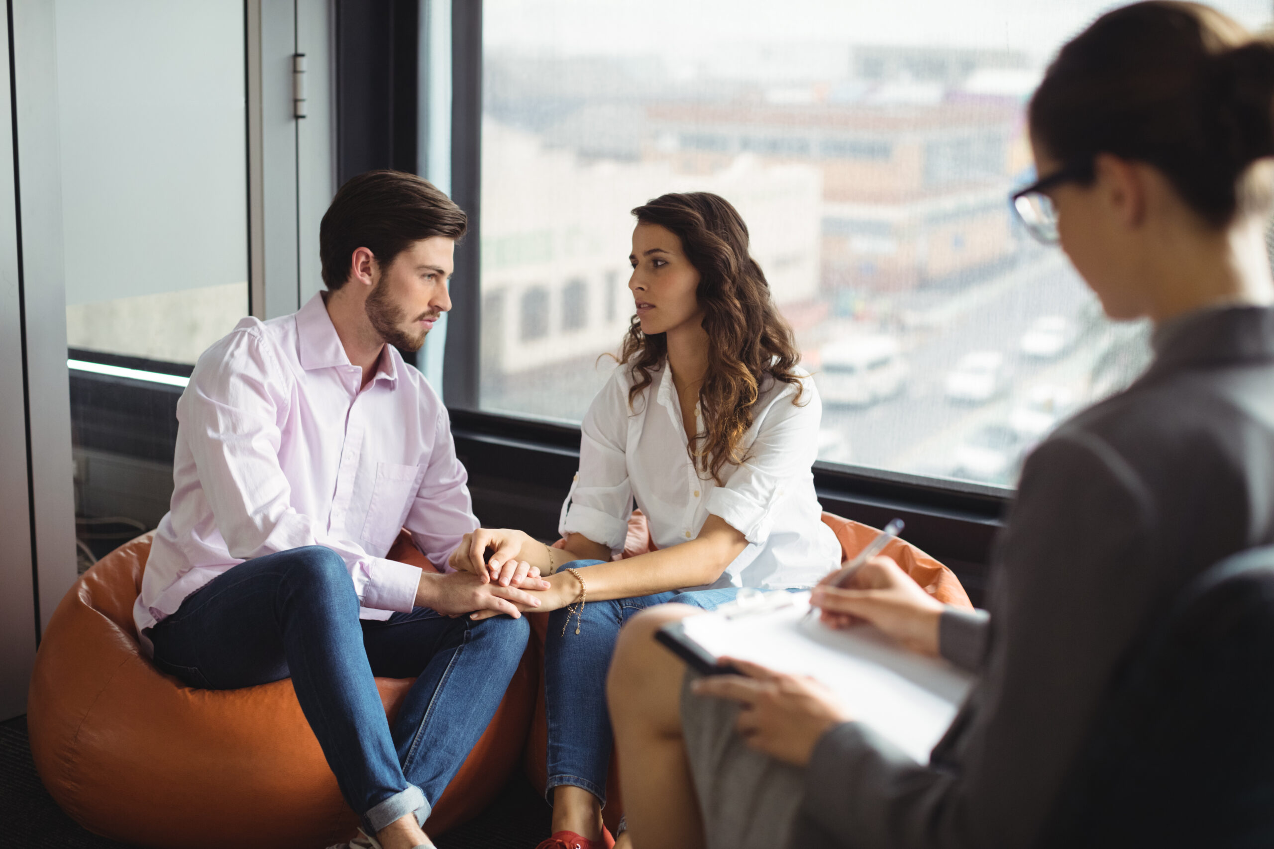 Couple talking to a marriage counselor during therapy