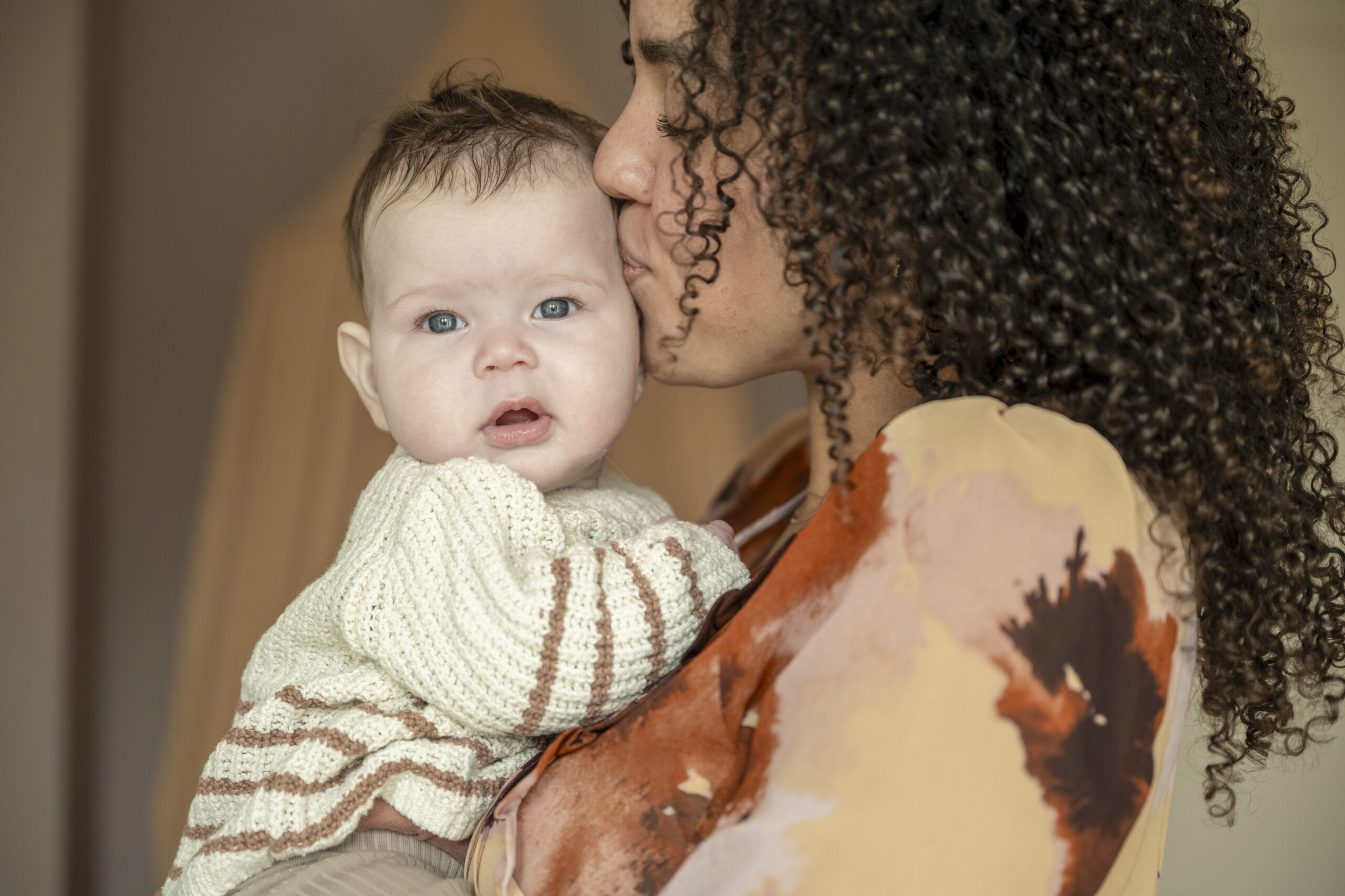 Young mother holding her adorable baby lovingly