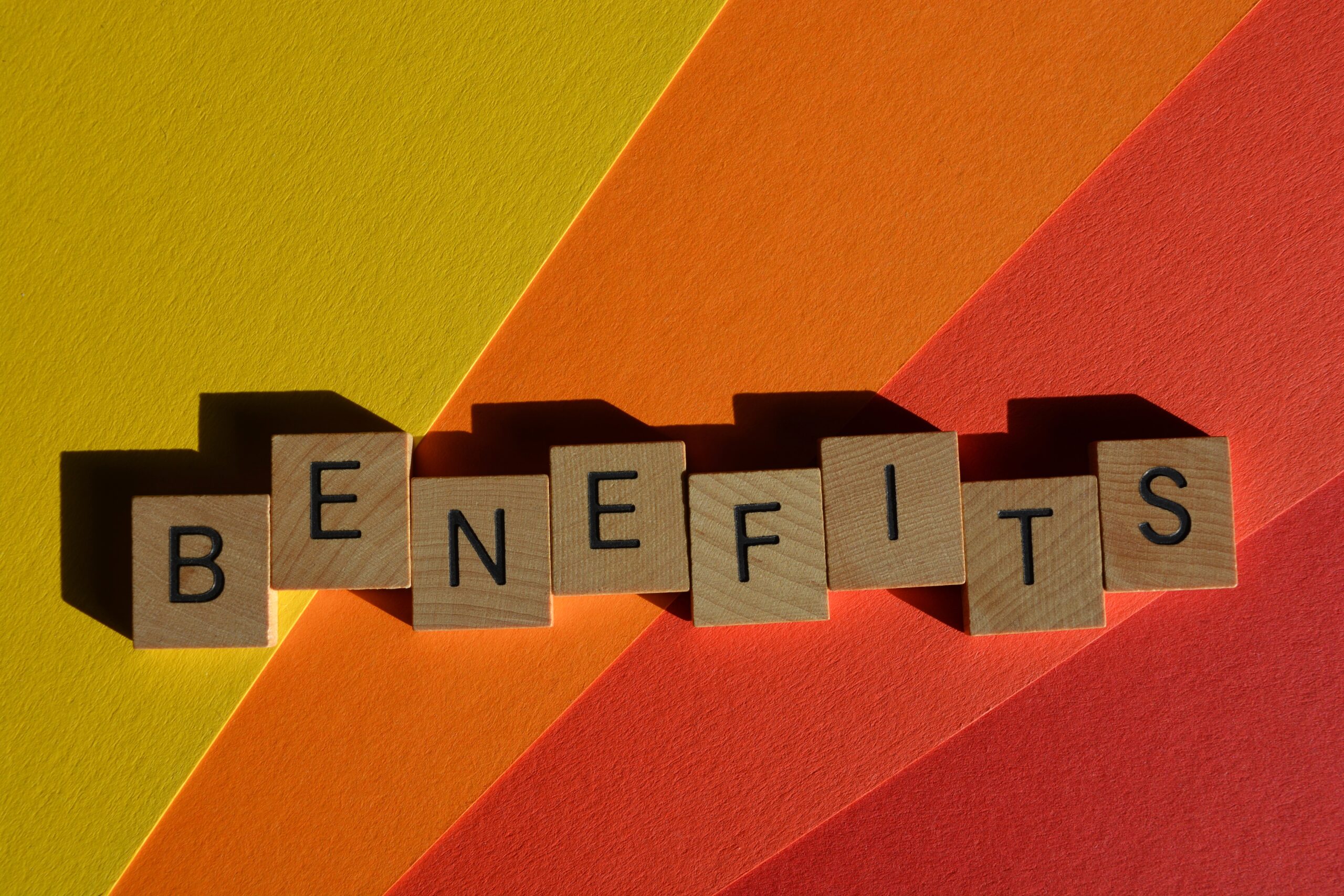 Benefits, word in wooden alphabet letters isolated on colourful background